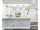 Modern basement bar with a stone feature wall at 4260 Columbus Dr, Hernando Beach, FL 34607