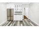 Modern kitchen with stainless steel appliances and white cabinets at 4260 Columbus Dr, Hernando Beach, FL 34607