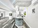 Modern basement bar with stone and white cabinetry at 4260 Columbus Dr, Hernando Beach, FL 34607