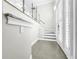 Modern staircase with glass railings and white trim at 4260 Columbus Dr, Hernando Beach, FL 34607