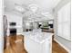 Elegant kitchen boasting white cabinets, marble island, and stainless steel appliances at 4260 Columbus Dr, Hernando Beach, FL 34607