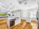 Open concept kitchen with large island, stainless steel sink, and hardwood floors at 4260 Columbus Dr, Hernando Beach, FL 34607