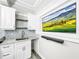 Basement wet bar with white cabinets, granite countertop and mosaic backsplash at 4260 Columbus Dr, Hernando Beach, FL 34607