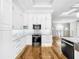 Modern kitchen with white cabinets, marble countertops, and stainless steel appliances at 4260 Columbus Dr, Hernando Beach, FL 34607