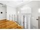 Elegant two-story foyer with glass and metal railing and hardwood floors at 4260 Columbus Dr, Hernando Beach, FL 34607