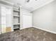 Spacious bedroom with built-in shelving and double closet at 4260 Columbus Dr, Hernando Beach, FL 34607
