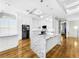 Gourmet kitchen featuring white cabinets, marble island, and hardwood floors at 4260 Columbus Dr, Hernando Beach, FL 34607