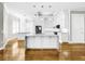 Modern kitchen with white cabinets, large island, and stainless steel appliances at 4260 Columbus Dr, Hernando Beach, FL 34607