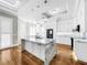 Bright kitchen with white cabinets, marble countertops, and an island at 4260 Columbus Dr, Hernando Beach, FL 34607