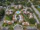 Aerial view of the community showcasing the layout of the buildings, pool area, landscaping and surrounding area at 2207 Belleair Rd # A32, Clearwater, FL 33764