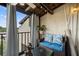 Cozy balcony featuring wood ceiling, comfortable wicker seating, and a view of the building exterior at 2207 Belleair Rd # A32, Clearwater, FL 33764