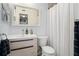 Stylish bathroom featuring a floating vanity with modern fixtures and a decorative mirror at 2207 Belleair Rd # A32, Clearwater, FL 33764