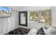 Bedroom view featuring a TV, a mirror, and a window view of a pool area at 2207 Belleair Rd # A32, Clearwater, FL 33764