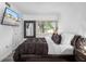 Serene bedroom with a plush bed, a large window, and a TV at 2207 Belleair Rd # A32, Clearwater, FL 33764