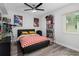 Bright bedroom featuring modern ceiling fan and laminate flooring at 2207 Belleair Rd # A32, Clearwater, FL 33764
