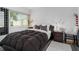 Comfortable bedroom with a bed, neutral wall color, and modern decor at 2207 Belleair Rd # A32, Clearwater, FL 33764