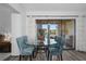 Dining area with glass table, upholstered chairs, and sliding doors to balcony at 2207 Belleair Rd # A32, Clearwater, FL 33764