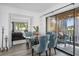 Charming dining area featuring a round table, upholstered chairs, and balcony access at 2207 Belleair Rd # A32, Clearwater, FL 33764