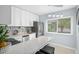 Modern kitchen featuring white cabinetry, stainless steel appliances, and sleek countertops at 2207 Belleair Rd # A32, Clearwater, FL 33764