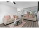 Comfortable living room with wood floors, mirrored wall, and stylish furnishings at 2207 Belleair Rd # A32, Clearwater, FL 33764