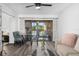 Living room combined with dining area, featuring stylish furniture and balcony access at 2207 Belleair Rd # A32, Clearwater, FL 33764