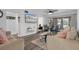 Cozy living room with a ceiling fan, modern furniture, and sliding glass doors to the balcony at 2207 Belleair Rd # A32, Clearwater, FL 33764