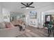 Bright living room with mirrored wall, ceiling fan, and access to dining area at 2207 Belleair Rd # A32, Clearwater, FL 33764