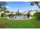 Community pool area surrounded by lush landscaping, fencing, and seating for residents to enjoy at 2207 Belleair Rd # A32, Clearwater, FL 33764