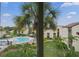 Scenic view of a community pool area surrounded by mature trees and well-maintained landscaping at 2207 Belleair Rd # A32, Clearwater, FL 33764