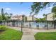 Well-maintained community pool area showcasing ample seating, shade, and lush landscaping at 2207 Belleair Rd # A32, Clearwater, FL 33764
