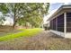 Backyard with fence, grass, and large trees at 2727 Featherstone Dr # 2727, Holiday, FL 34691