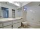 Bathroom with tub, toilet, and vanity with sink at 2727 Featherstone Dr # 2727, Holiday, FL 34691