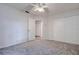 Carpeted bedroom includes closet and fan at 2727 Featherstone Dr # 2727, Holiday, FL 34691