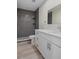 Nicely remodeled bathroom features modern vanity, fixtures, and walk-in shower with dark tile at 4632 Marine Pkwy # 302, New Port Richey, FL 34652