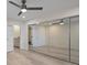 Spacious bedroom featuring mirrored closet doors and doorways to bathroom and hallway at 4632 Marine Pkwy # 302, New Port Richey, FL 34652