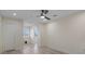 Bright bedroom featuring a ceiling fan, light wood floors, and large window at 4632 Marine Pkwy # 302, New Port Richey, FL 34652