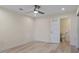 Spacious bedroom with light wood flooring and doorway to en-suite bathroom at 4632 Marine Pkwy # 302, New Port Richey, FL 34652