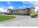 Exterior view of a multi-story building with covered parking and landscaped grounds at 4632 Marine Pkwy # 302, New Port Richey, FL 34652