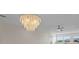 An elegant capiz shell chandelier and ceiling fan provide lighting to the living room at 4632 Marine Pkwy # 302, New Port Richey, FL 34652