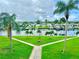Picture of a manicured green lawn area with sidewalks, landscaping and water view at 4632 Marine Pkwy # 302, New Port Richey, FL 34652