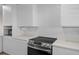 Well-lit kitchen with white cabinets, modern appliances, and stylish backsplash at 4632 Marine Pkwy # 302, New Port Richey, FL 34652