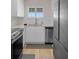 Well-lit kitchen featuring white cabinets, stainless steel appliances, and modern design elements at 4632 Marine Pkwy # 302, New Port Richey, FL 34652
