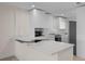 Modern kitchen with white cabinets, stainless steel appliances, and a unique marble countertop at 4632 Marine Pkwy # 302, New Port Richey, FL 34652