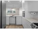 Open kitchen design flowing into a living area, featuring modern white cabinets and countertops at 4632 Marine Pkwy # 302, New Port Richey, FL 34652