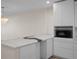 Contemporary kitchen featuring a unique marble countertop, white cabinetry, and modern lighting at 4632 Marine Pkwy # 302, New Port Richey, FL 34652