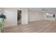 Bright open-concept living area with light wood floors and stylish modern finishes at 4632 Marine Pkwy # 302, New Port Richey, FL 34652