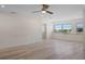 Bright living room with hardwood floors, ceiling fan and lots of natural light from windows at 4632 Marine Pkwy # 302, New Port Richey, FL 34652