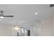 Living room with hardwood floors and view of the kitchen featuring a gorgeous chandelier at 4632 Marine Pkwy # 302, New Port Richey, FL 34652