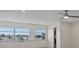Bright living room featuring windows with plant accents, hardwood floors, and ceiling fan at 4632 Marine Pkwy # 302, New Port Richey, FL 34652