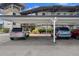 Assigned covered parking area for residents, with well-maintained landscaping at 4632 Marine Pkwy # 302, New Port Richey, FL 34652